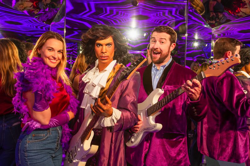 Guest posing with wax figure