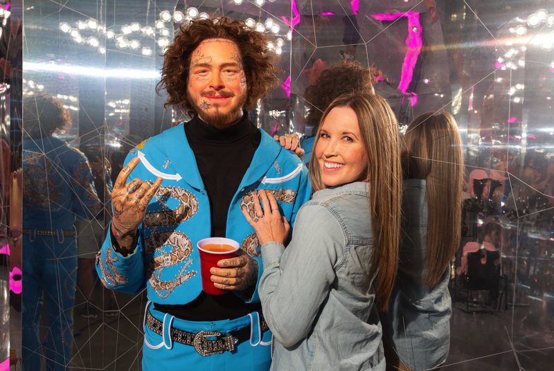 Guest posing with wax figure