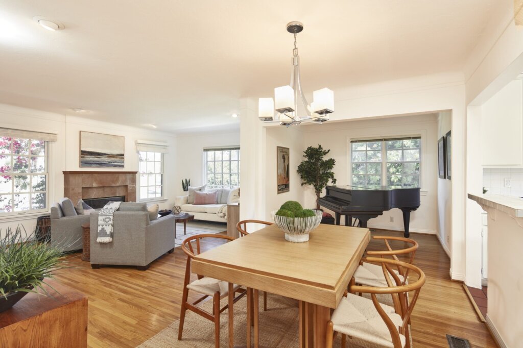 After: the same rooms painted white and fully staged with a dining table and seating